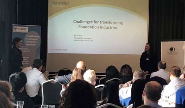 Professor Vera Trappmann and Professor Susan Bernal stood in front of a presentation on Challenges for transforming Foundation Industries, in front of an audience.