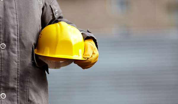 Worker holding a hard hat