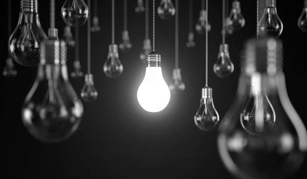 Black and white light bulbs: central bulb is lit